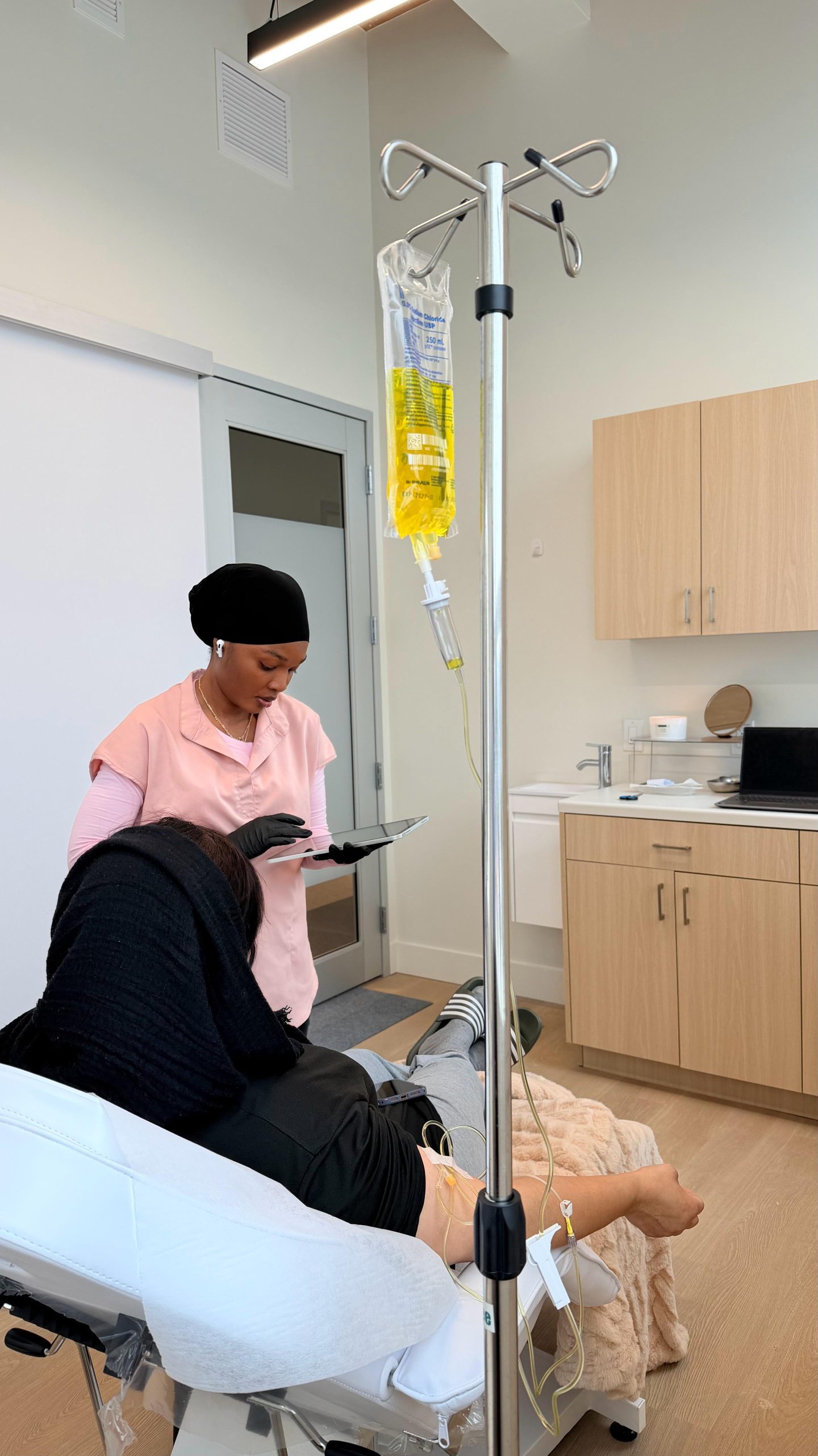 Client relaxing during IV wellness at Mintus Laser Clinic